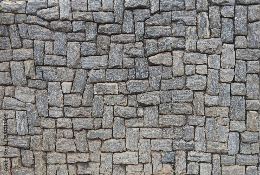 Fototapeta premium texture composed of ornamental gray stones in different tones and variable sizes, with irregular relief harmoniously arranged