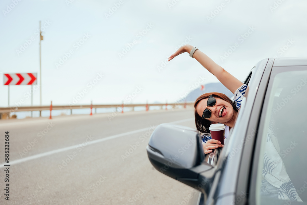 Happy smiling young woman passenger showing thumb up hand drinking takeaway coffee Happy smiling young woman passenger showing thumb up hand drinking takeaway coffee