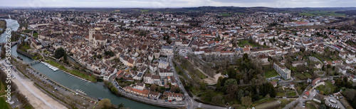 Aerial around the old town of the city Dole in France on a cloudy afternoon in late winter