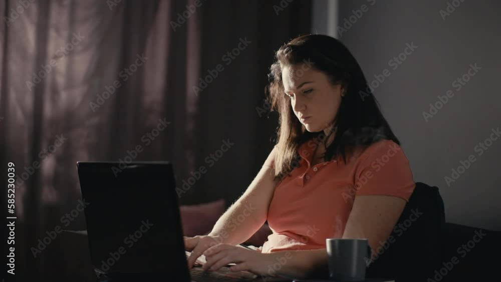 Caucasian woman works at the computer with coffee in the morning. Businesswoman solves cases in the home office. Remote work online on a laptop. High quality 4k footage Caucasian woman works at the computer with coffee in the morning. Businesswoman solves cases in the home office. Remote work online on a laptop. High quality 4k footage