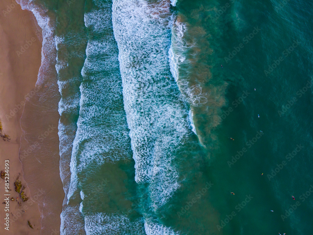 Drone, aerial view of large waves splashing on the rocks. Turquoise water and golden sand during sunrise. The stunning second bay of Coolum, Sunshine Coast, Queensland, Australia. Drone, aerial view of large waves splashing on the rocks. Turquoise water and golden sand during sunrise. The stunning second bay of Coolum, Sunshine Coast, Queensland, Australia.