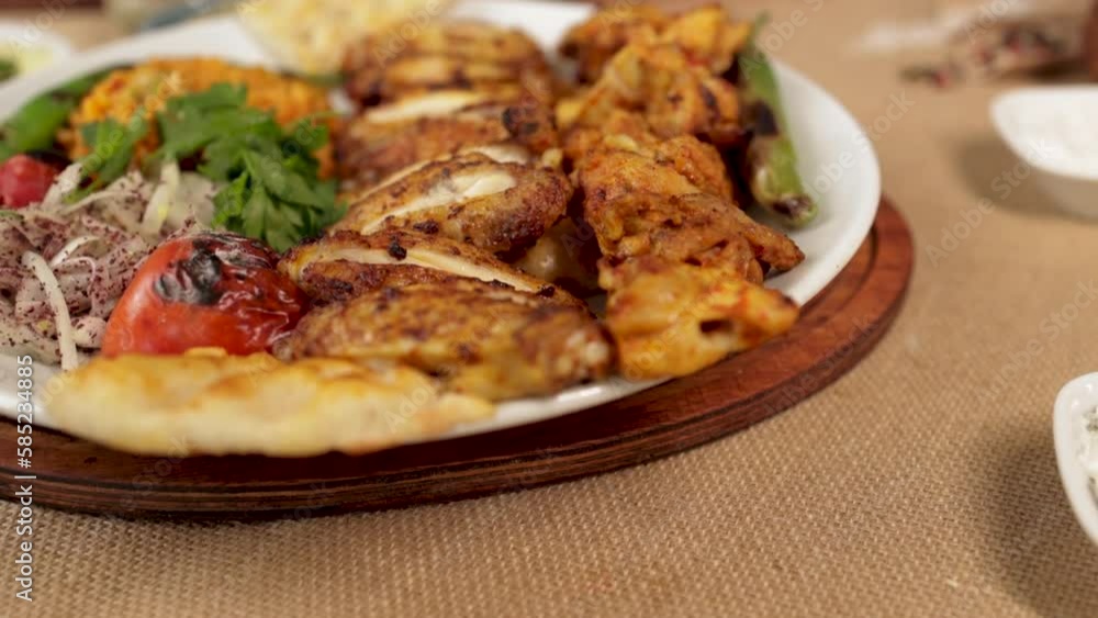 Video shooting of traditional Turkish kebab from top angle, bottom angle and side angle. There are oil pots, spices, yoghurt appetizers, spicy appetizers and on the table. Horizontal videos. Video shooting of traditional Turkish kebab from top angle, bottom angle and side angle. There are oil pots, spices, yoghurt appetizers, spicy appetizers and on the table. Horizontal videos.