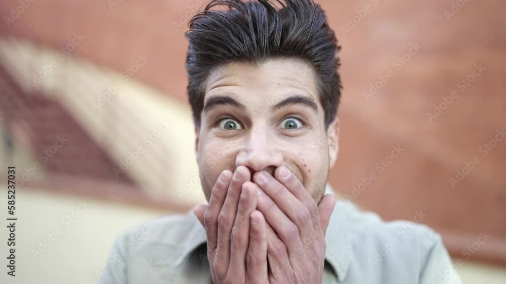 Young hispanic man standing with surprise expression at street Young hispanic man standing with surprise expression at street
