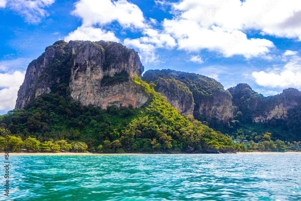 Tropical paradise turquoise water beach and limestone rocks Krabi Thailand.