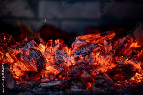 Flame of fire from hot burning coals in the fireplace. Heat from the oven. 
