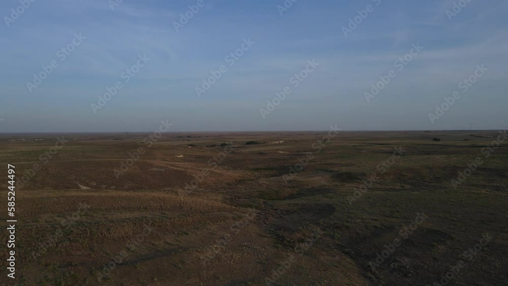2022 - aerial over the vast dry barren flat prairie lands near Great Bend, Kansas. 2022 - aerial over the vast dry barren flat prairie lands near Great Bend, Kansas.