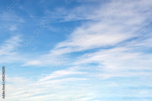 Beautiful blue sky with large white clouds backdrop. April weather spring sky background