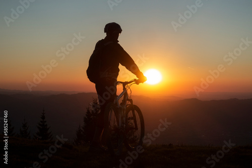 silhouette of a mountain biker towards a wonderful sunset