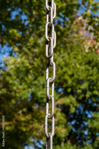 metal chain hanging vertically. close up shot. Background 