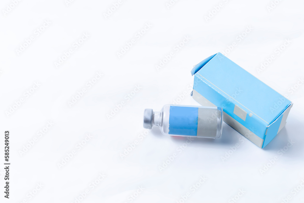 Medical ampoule with box on white background with copy space for text. Vaccination concept. Medical ampoule with box on white background with copy space for text. Vaccination concept.