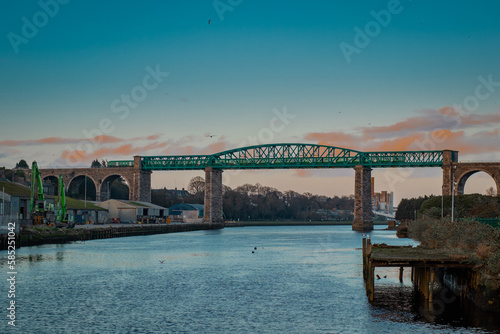 Amazing Boyne viaduct in drogheda spanning over river Boyne in early evening hours. Beautiful pucture of a green metal viaduct and stone arches.