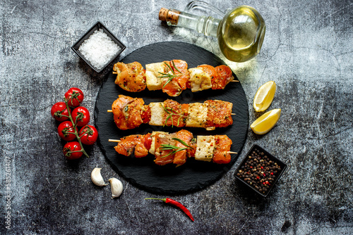 raw salmon skewers on skewers on a stone background.Raw seafood on skewers