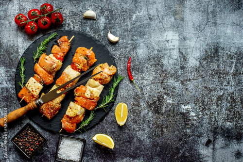 raw salmon skewers on skewers on a stone background with copy space for your text .Raw seafood on skewers