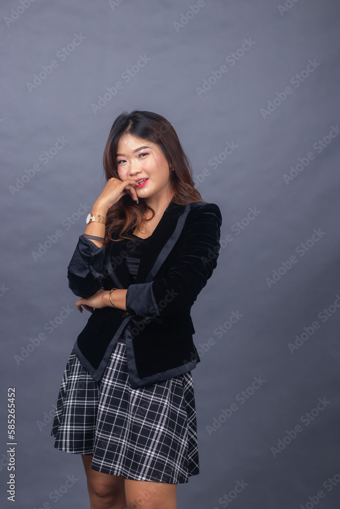 beautiful chinese asian women dressed in formal office wear jackets and skirts. girl expression smiling happy in formal pose her hands are tight and hold cheeks beautiful chinese asian women dressed in formal office wear jackets and skirts. girl expression smiling happy in formal pose her hands are tight and hold cheeks