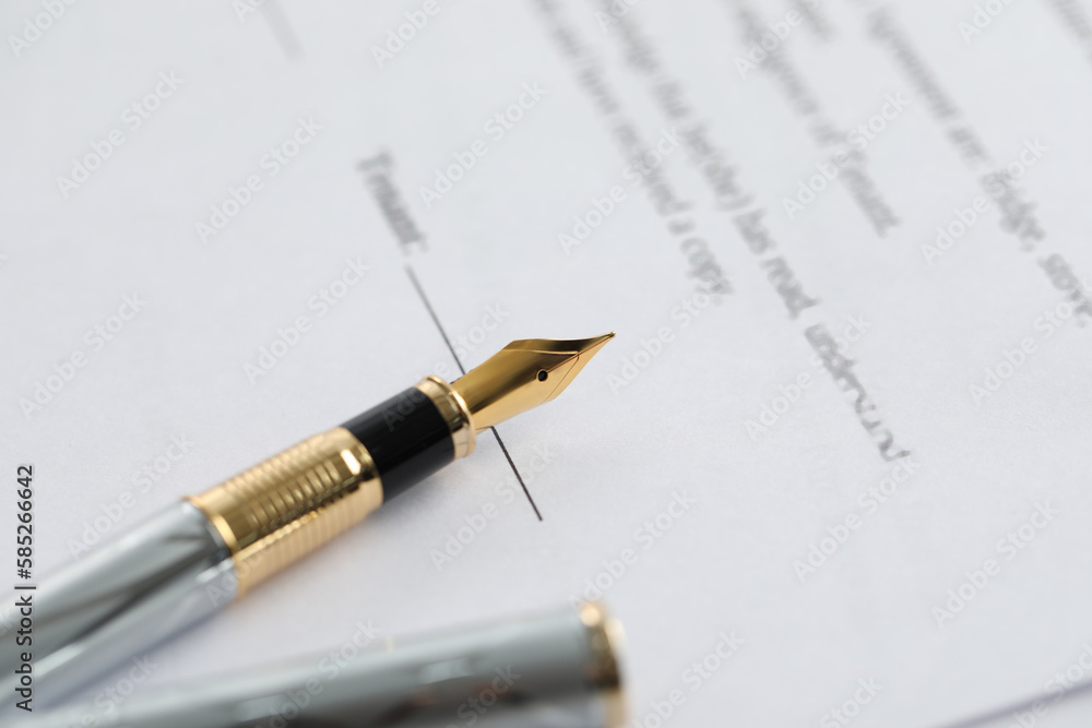 Fountain pen on paper document, closeup. Notary services Fountain pen on paper document, closeup. Notary services