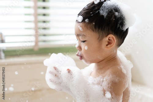 boy taking a bath in the tub take bath he plays with bubbles