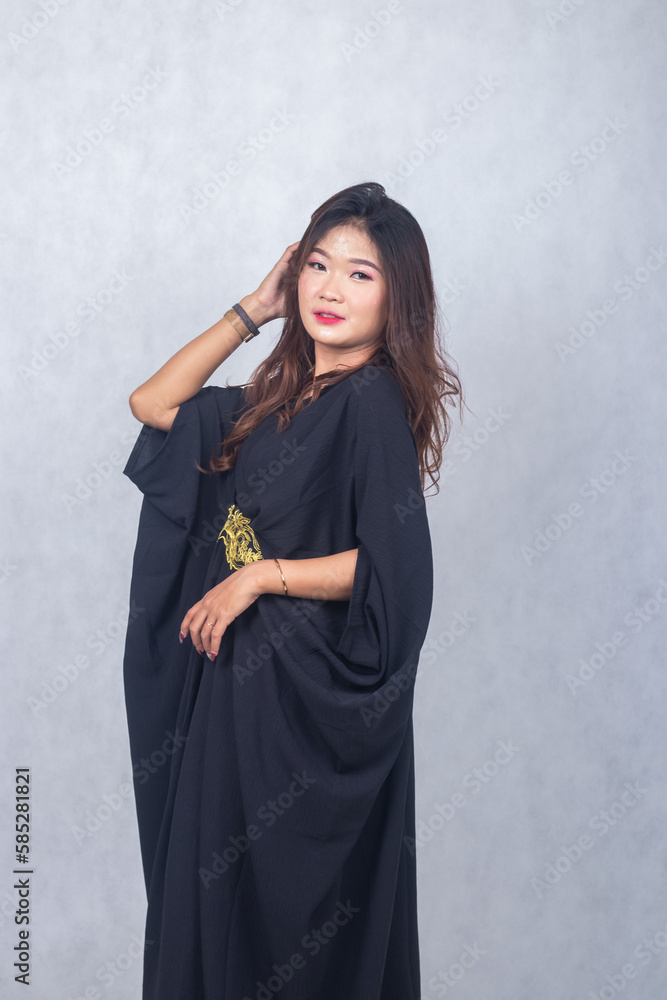 Asian chinese muslim headscarf hijab woman greeting ramadan fasting eid al fitr and eid al adha on white background. smiling expression of girl hand holding hair Asian chinese muslim headscarf hijab woman greeting ramadan fasting eid al fitr and eid al adha on white background. smiling expression of girl hand holding hair
