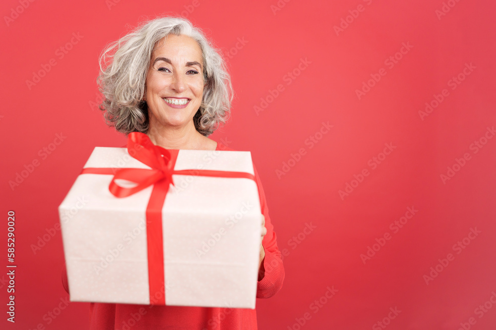 A happy mature woman giving a gift A happy mature woman giving a gift
