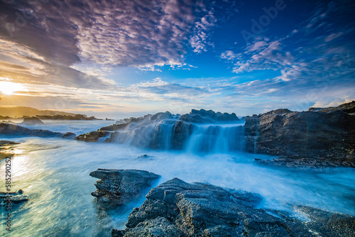 Waterfall at the rocky beach