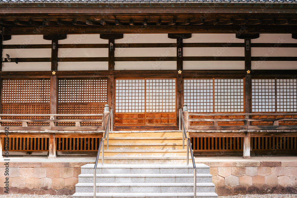 Frontal view of a Japanese temple with wooden beams and a staircase in the middle. The facade impresses with the traditional square paper windows. Frontal view of a Japanese temple with wooden beams and a staircase in the middle. The facade impresses with the traditional square paper windows.