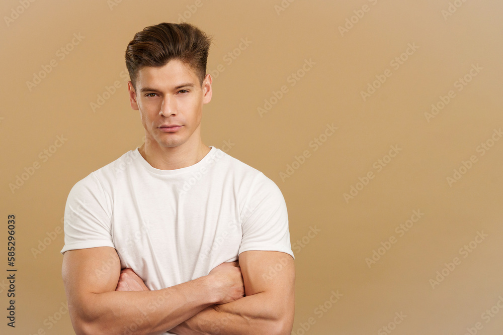 Proud strong man looking at camera with arms folded Proud strong man looking at camera with arms folded
