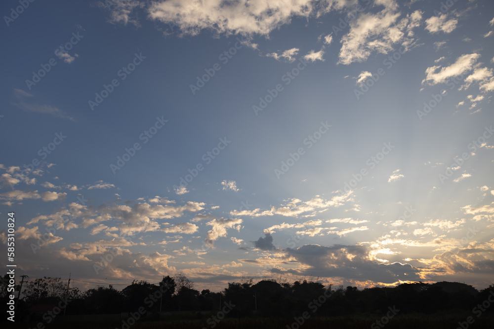 Fototapeta premium Beautiful sky and cloud at high. Landscape include space, light of nature, sunset, sunrise, horizon or skyline. Colorful with yellow, orange and blue at evening in autumn for background and wallpaper.