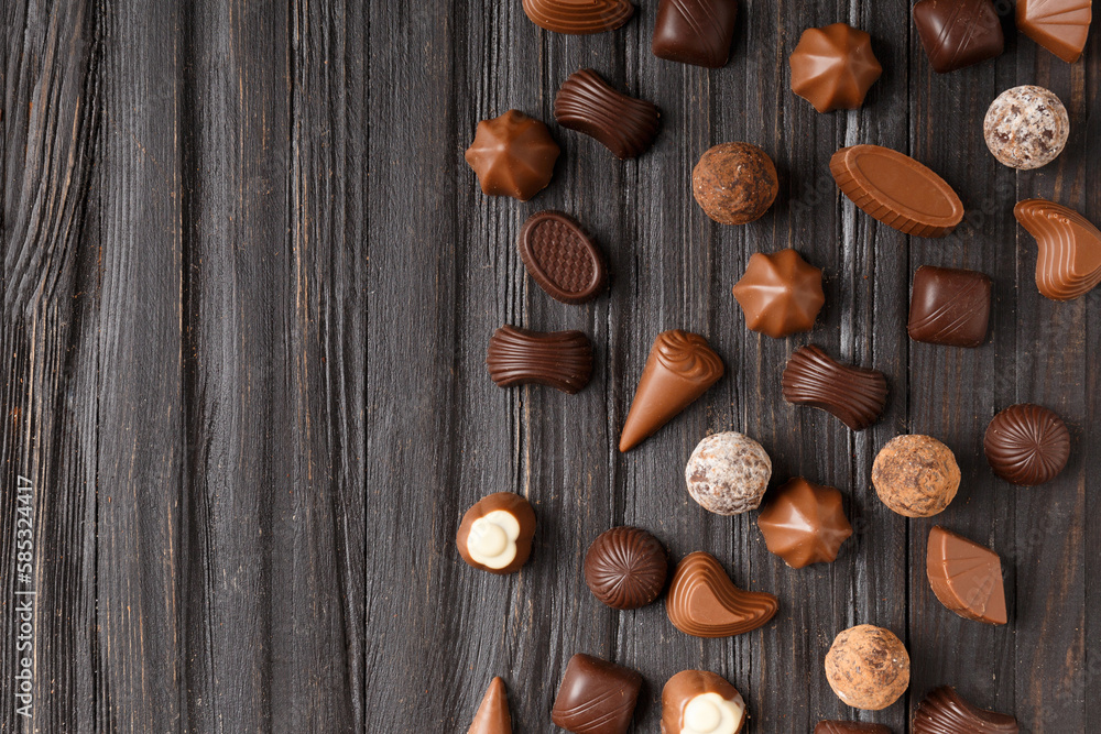 Assorted chocolates on dark wooden background top view Assorted chocolates on dark wooden background top view