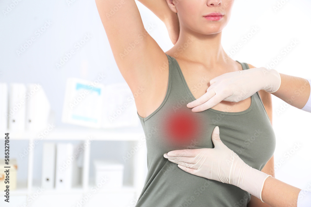 Doctor checking woman's breast at hospital, closeup Doctor checking woman's breast at hospital, closeup