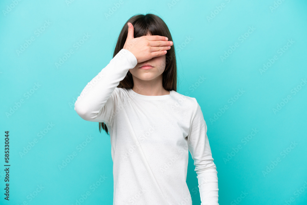Little caucasian girl isolated on blue background covering eyes by hands. Do not want to see something Little caucasian girl isolated on blue background covering eyes by hands. Do not want to see something