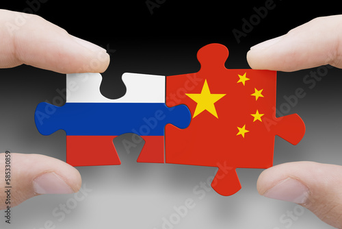 Puzzle made from flags of Russia and China. Russia and China relations and military collaboration photo