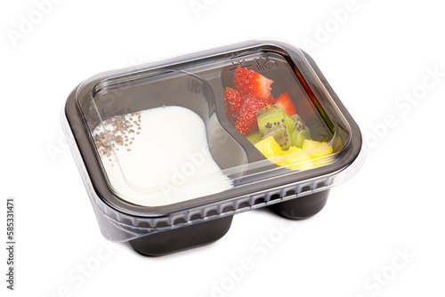 Portion of yogurt dessert with strawberry and kiwi and pineapple in a plastic bowl with a lid.