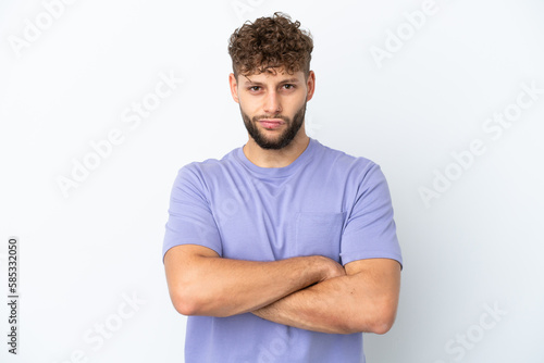 Young handsome caucasian man isolated on white background with unhappy expression