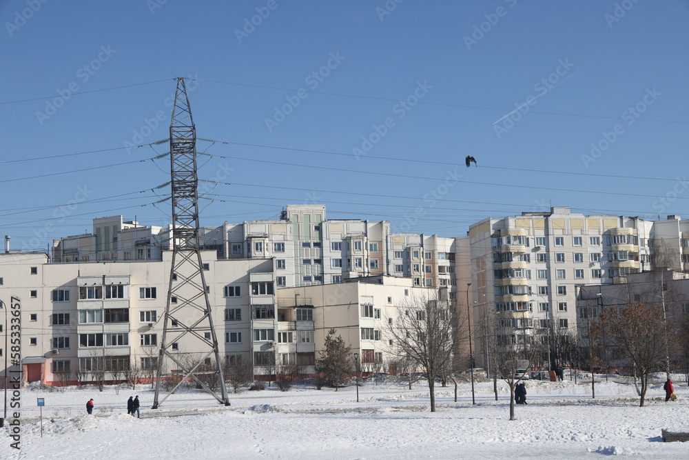Landscapes in the park with melting snow, puddles and ice in spring. Residential buildings and spring landscapes of Butovo, Moscow, thawed patches, March 2023.