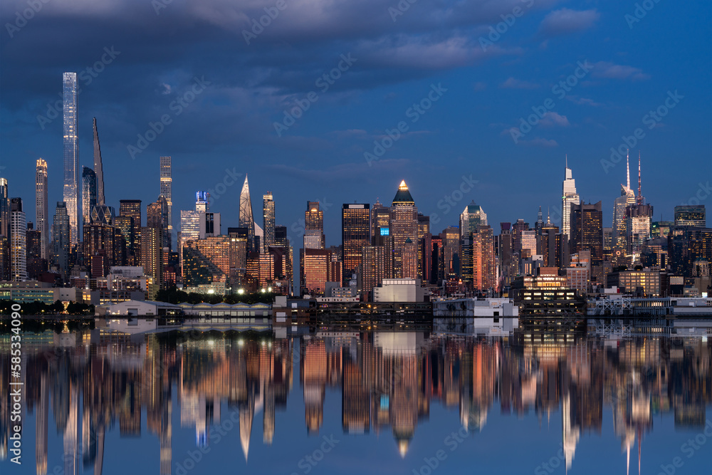 Skyscrapers of New York city and their reflection in water at night