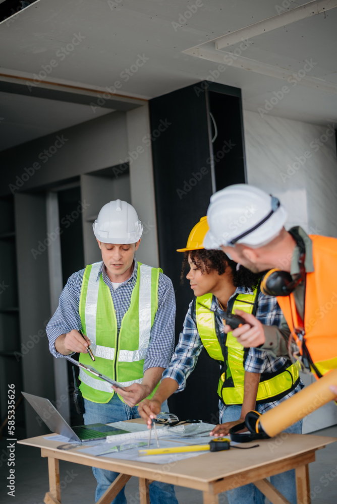 Architect caucasian man working with colleagues mixed race in the construction site. Architecture engineering on big project. Building in construction interior. Architect caucasian man working with colleagues mixed race in the construction site. Architecture engineering on big project. Building in construction interior.