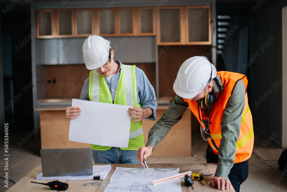 Engineers are discussing data working and laptop or tablet with architectural project at new construction site on big project.. Engineers are discussing data working and laptop or tablet with architectural project at new construction site on big project..