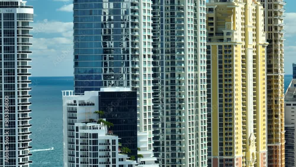 Expensive highrise hotels and condos on Atlantic ocean shore in Sunny Isles Beach city. American tourism infrastructure in southern Florida Expensive highrise hotels and condos on Atlantic ocean shore in Sunny Isles Beach city. American tourism infrastructure in southern Florida