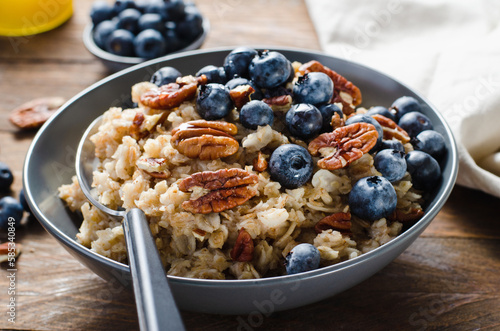 Oatmeal Bowl, Oat Porridge with Blueberry and Pecans in a Bowl on Rustic Background, Healthy Snack or Breakfast