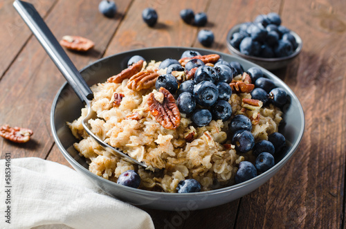 Oatmeal Bowl, Oat Porridge with Blueberry and Pecans in a Bowl on Rustic Background, Healthy Snack or Breakfast