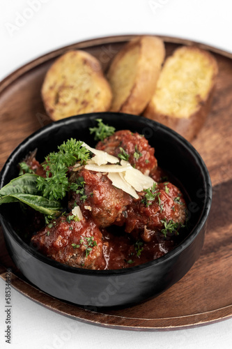 italian traditional beef meatballs with tomato sauce on wood board