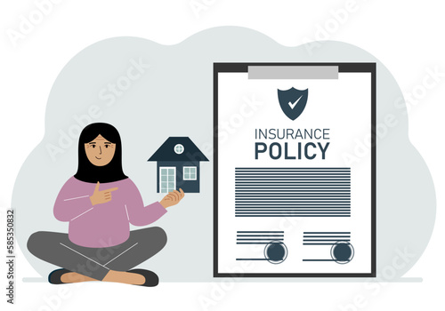 A woman holds in his hands at home next to a large insurance contract. Home and real estate insurance concept.