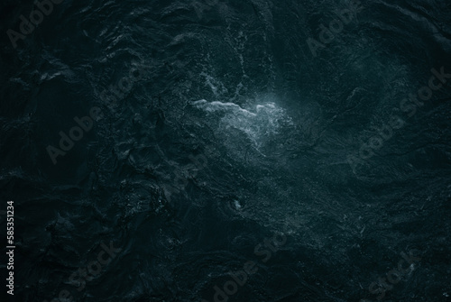 View on dark water of mountain river in Alps