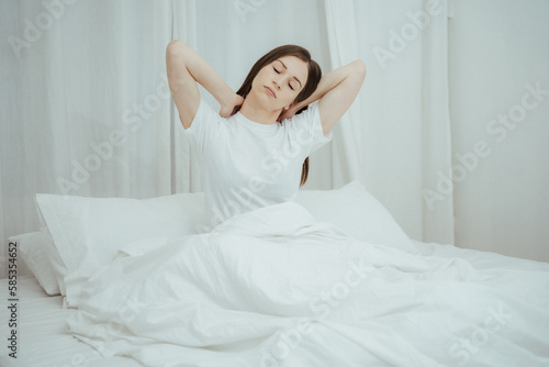 Wallpaper Mural Top view of attractive young smiling woman smiling and stretching while lying on the bed at home Torontodigital.ca