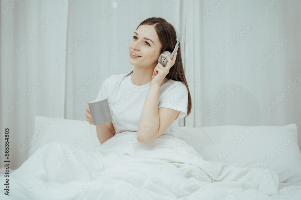 Beautiful girl at her bedroom drinking tea in the morning. Beautiful girl at her bedroom drinking tea in the morning.