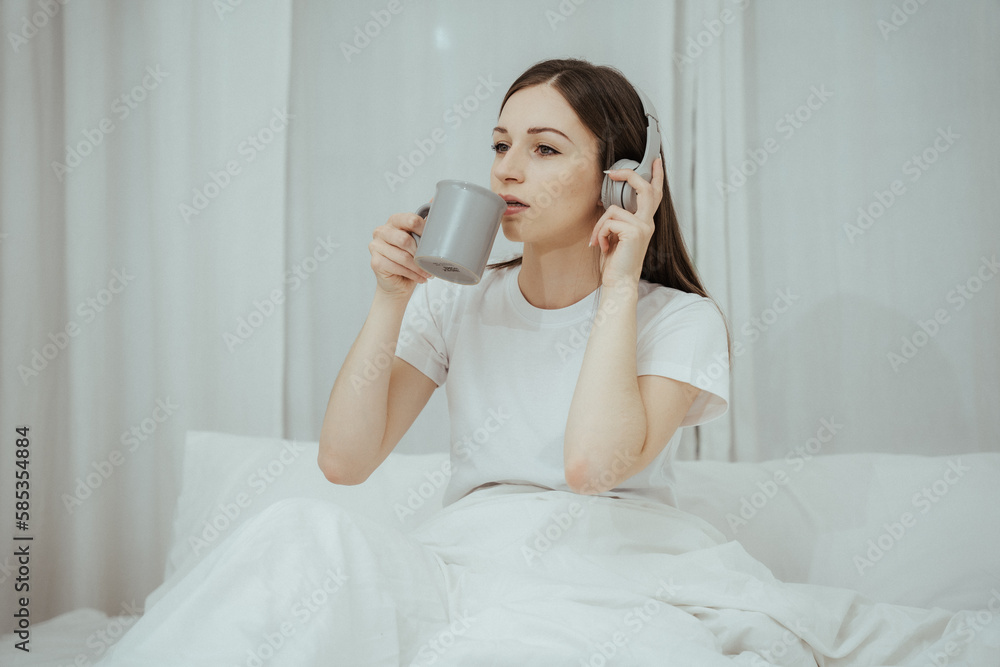 Beautiful girl at her bedroom drinking tea in the morning. Beautiful girl at her bedroom drinking tea in the morning.