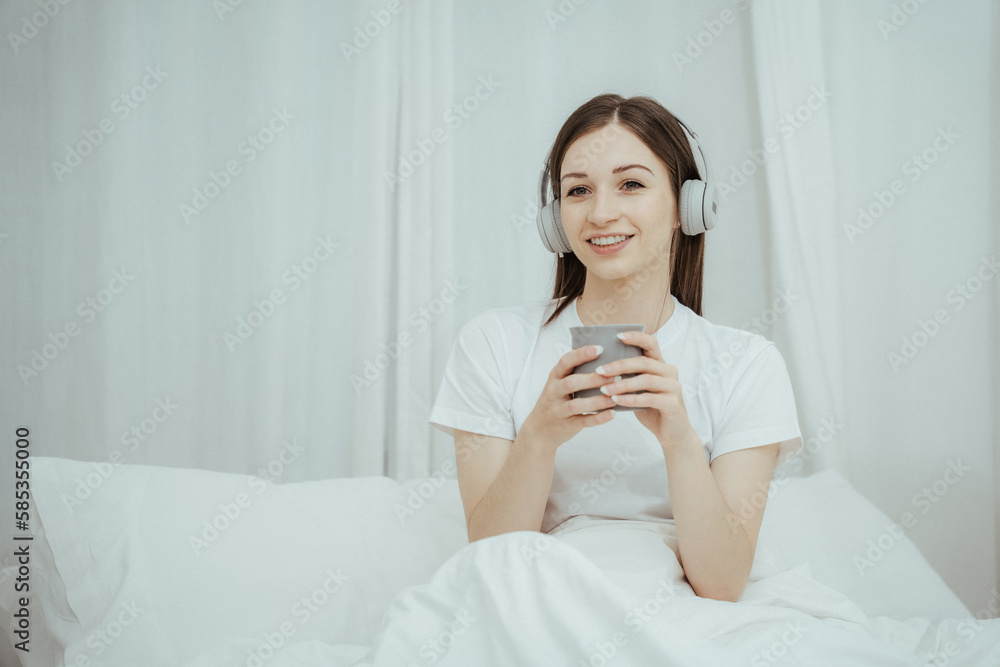 Beautiful girl at her bedroom drinking tea in the morning. Beautiful girl at her bedroom drinking tea in the morning.