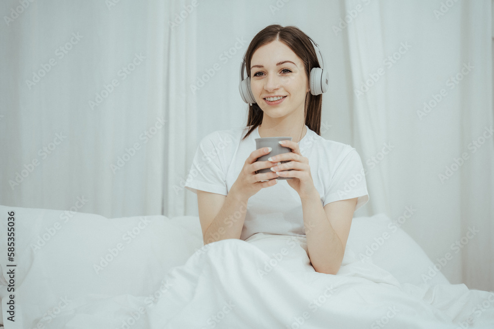Beautiful girl at her bedroom drinking tea in the morning. Beautiful girl at her bedroom drinking tea in the morning.
