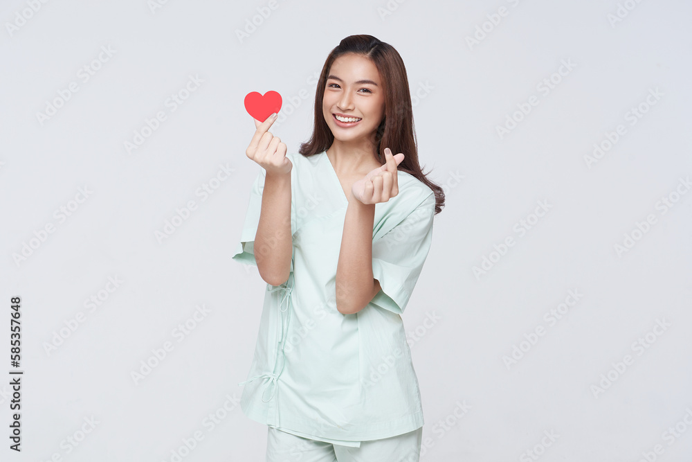 Happy smile asian woman patient showing heart isolated on white background. Insurance cardiovascular and cardiac concept. Happy smile asian woman patient showing heart isolated on white background. Insurance cardiovascular and cardiac concept.