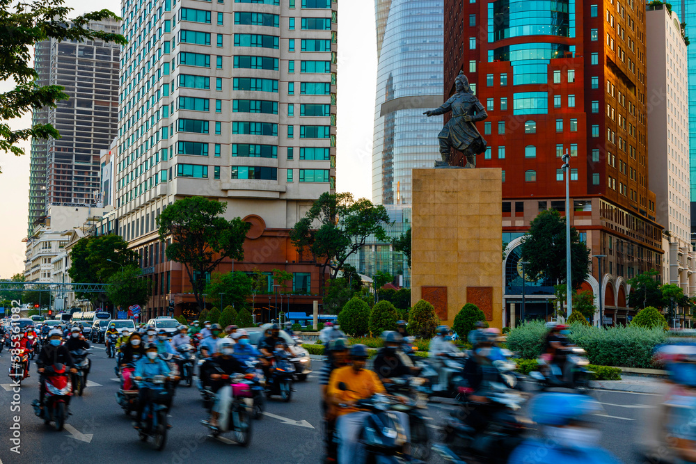 colorful long exposure street perspective in Ho Chi Minh City with people and motorbikes overlooking 