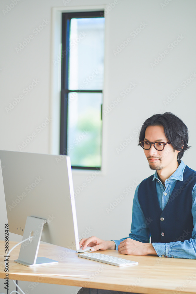 自宅でリモートワークをする若い男性 自宅でリモートワークをする若い男性
